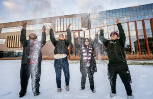 Students throwing snow in air outside of Hagfors